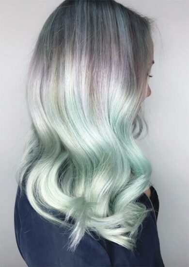 a woman's hair with a gradient in mint color 