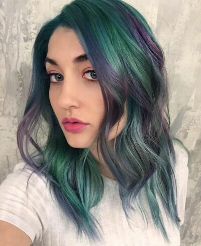 selfie of a girl showing the color of her mint hair with purple 