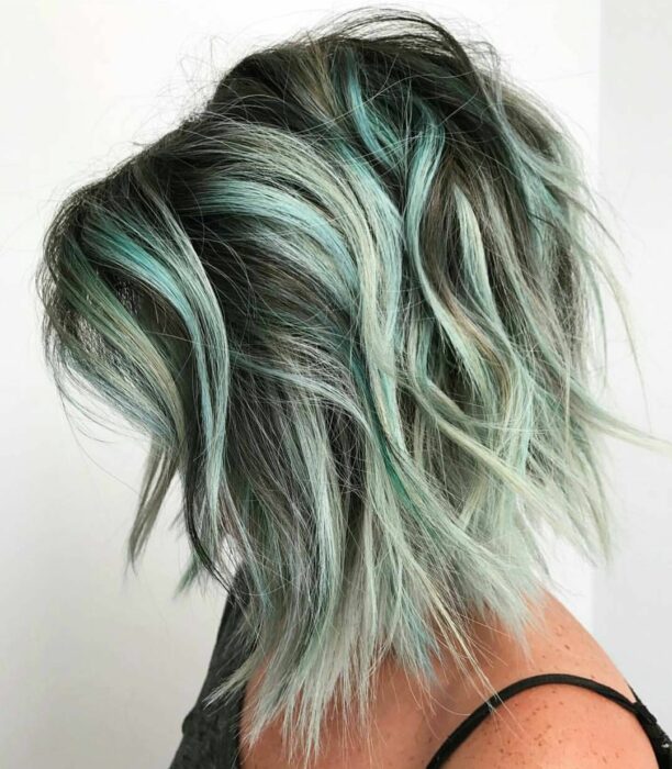 short hair of a girl with highlights in mint color 