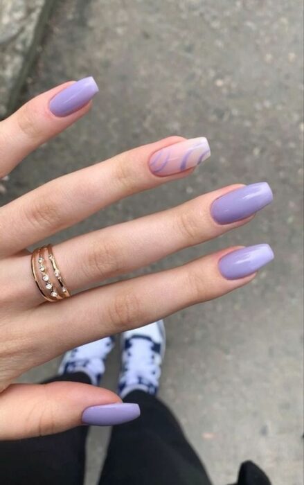 lilac acrylic nails with one in a different color 