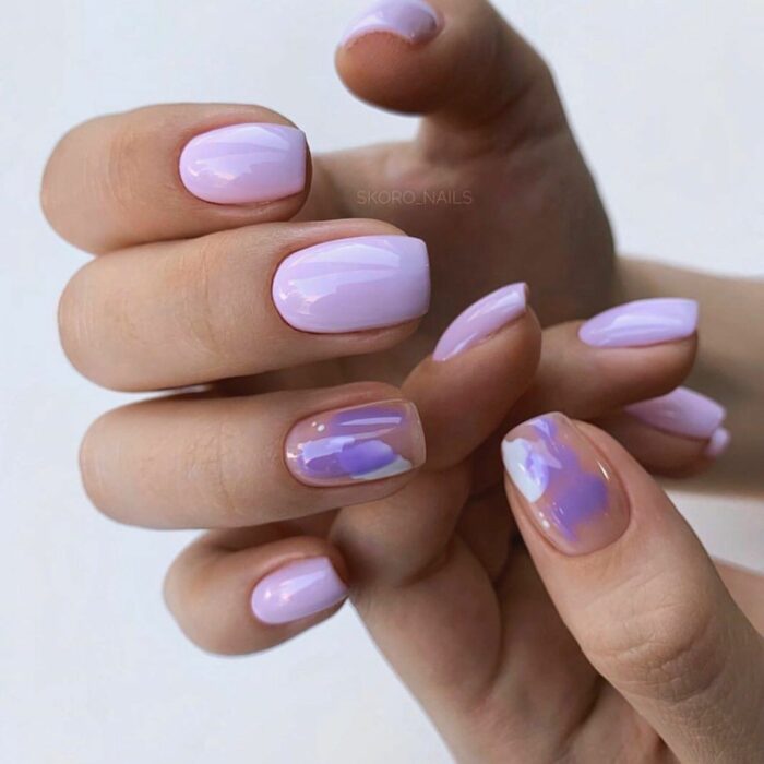 lilac acrylic nails with a detail on the ring finger 