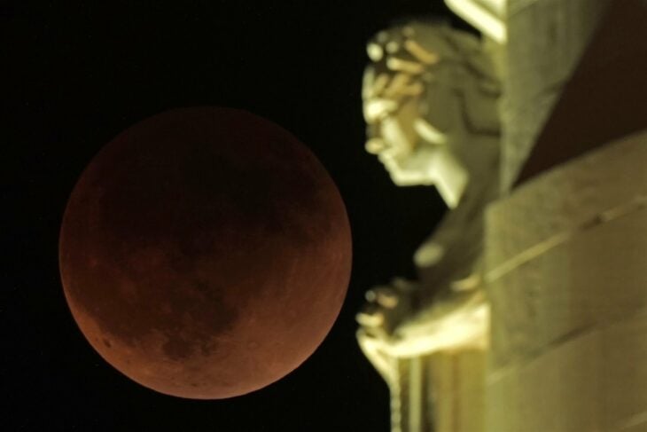 Lunar eclipse 2022 next to the Liberty Memorial tower in Kansas City, United States.