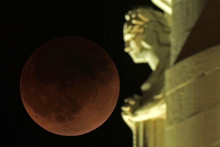 Lunar eclipse 2022 next to the Liberty Memorial tower in Kansas City, United States.