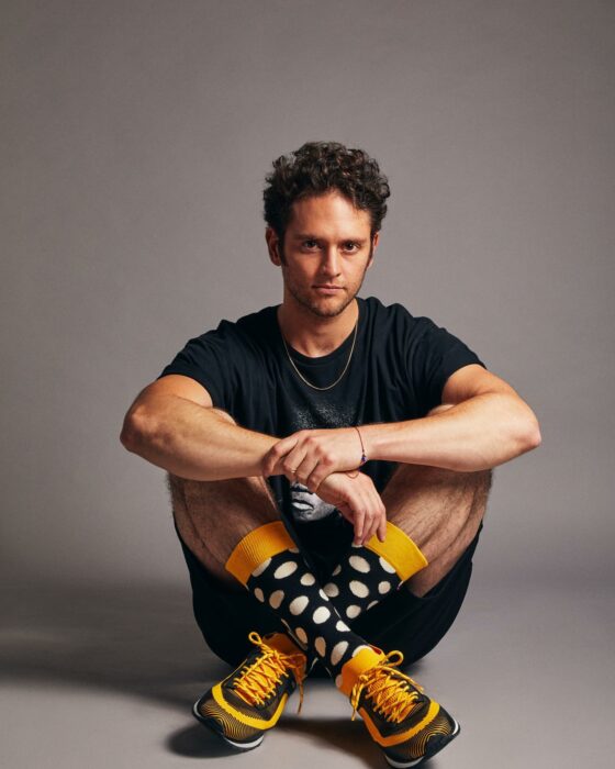 Christopher Uckermann sitting dressed in a footballer's jersey 