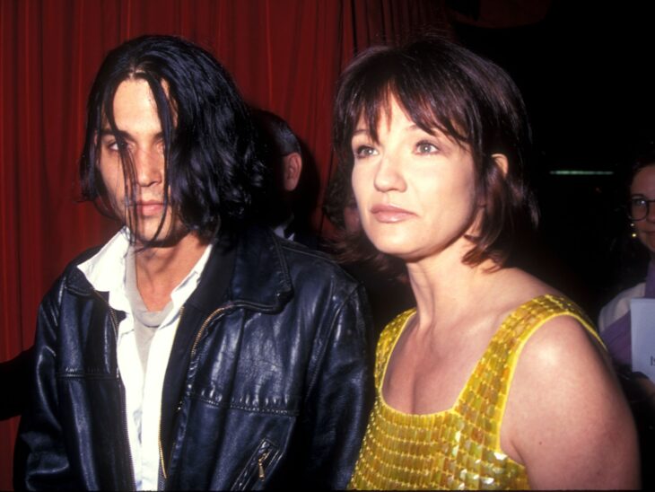 Photograph of Johnny Depp next to actress Ellen Barkin in 1998