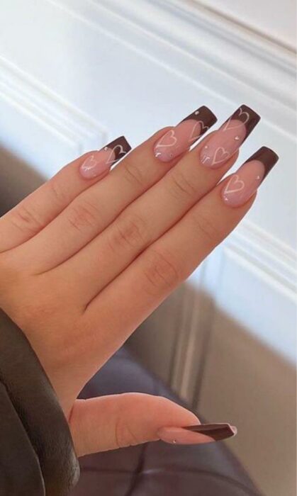 brown french acrylic nails with rhinestones and heart designs 