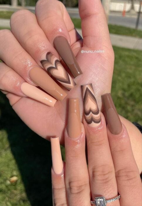 brown acrylic nails with an aesthetic heart design nail 