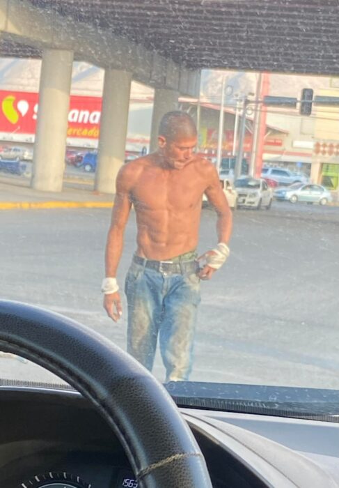 Photograph of a boy on the street without a shirt 