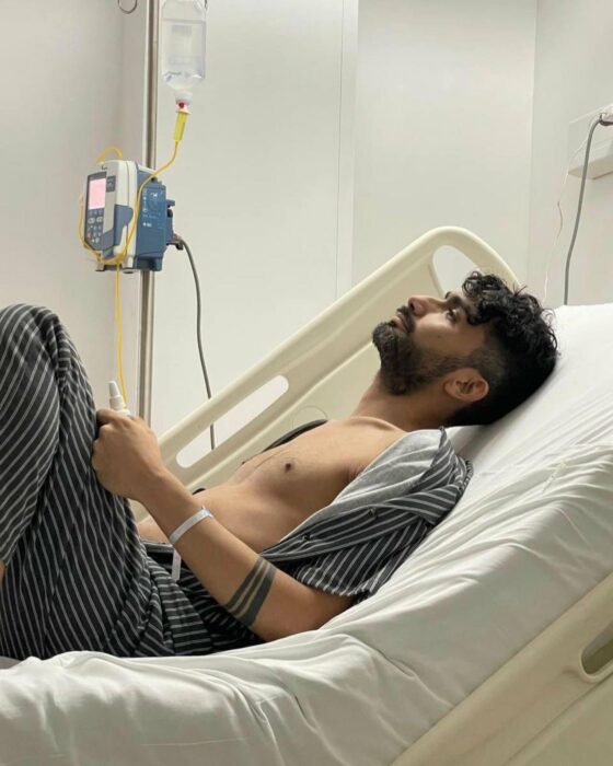 man lying on hospital bed looking up at ceiling 