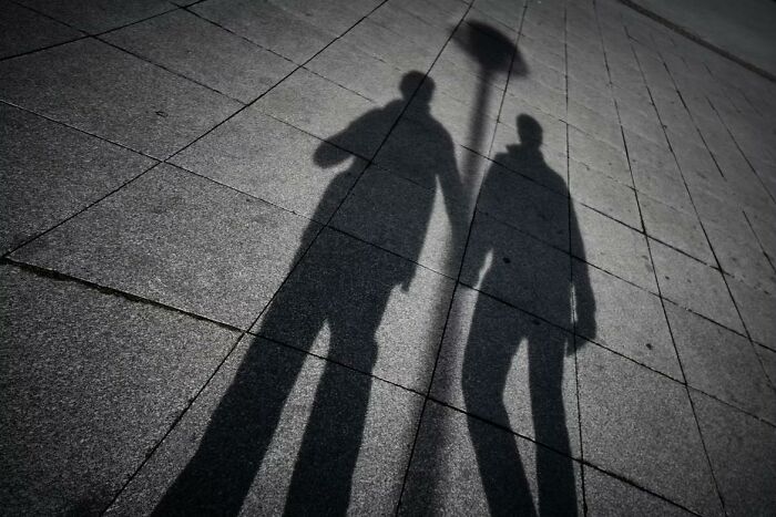 shadow of couple holding hands