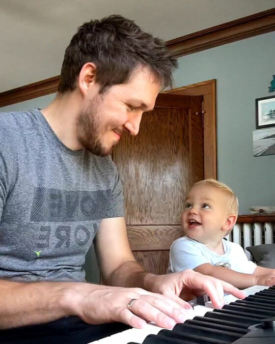 dad and son playing the piano