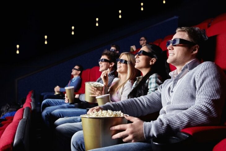 people watching the cinema screen in a room 