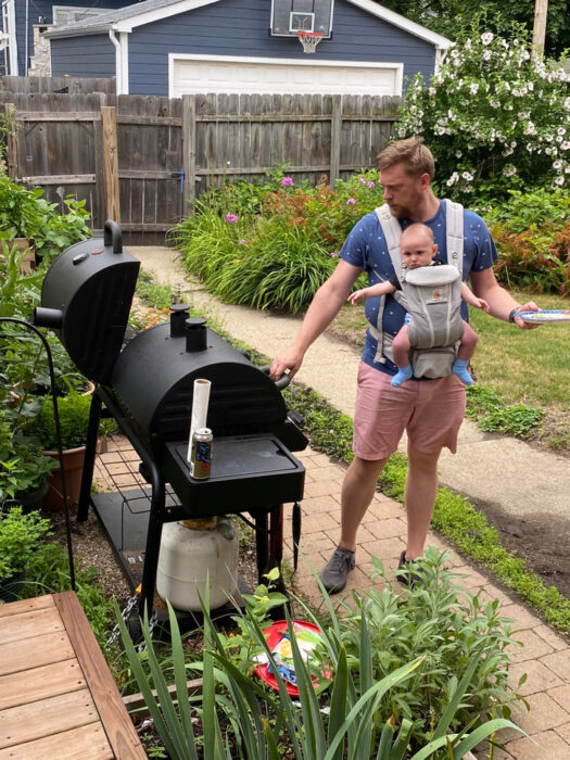 dad with his son carrying him in barbecue