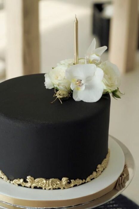 black cake with white roses