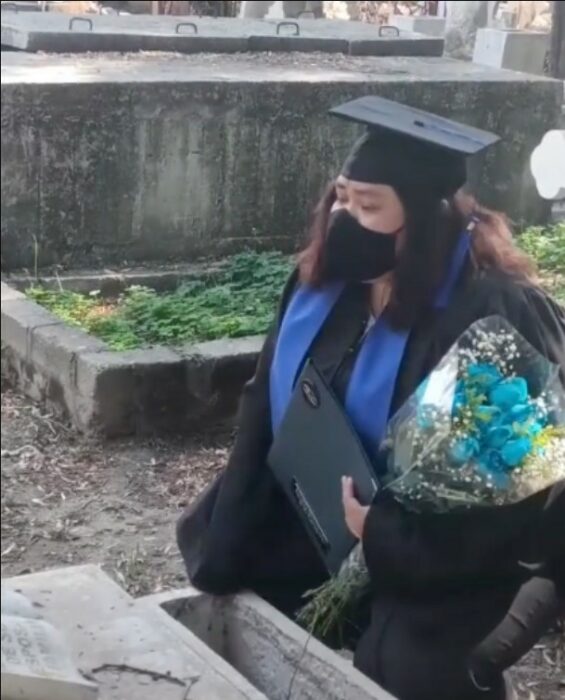 Proud girl finishes her degree and takes her university degree to her father's grave