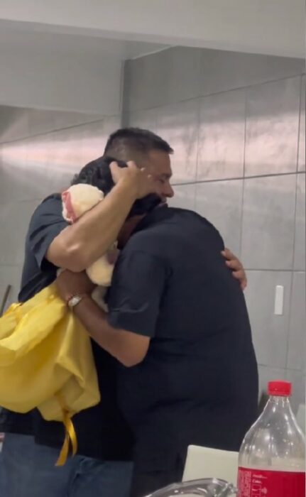 man hugging a widower who received a teddy bear with the voice of his late wife 