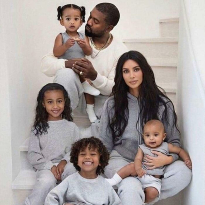 Kim Kardashian and Kanye West posing with their children 