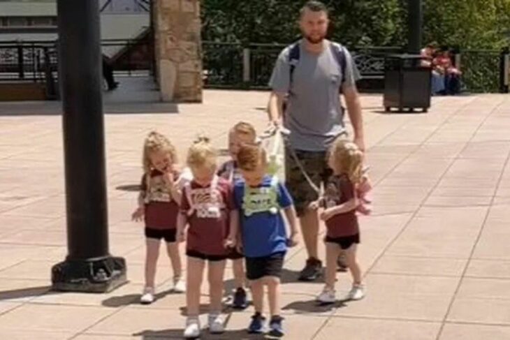 daddy of quintuplets walking with leashes