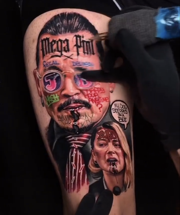arm of a person tattooed with the faces of Johnny Depp and Amber Heard 