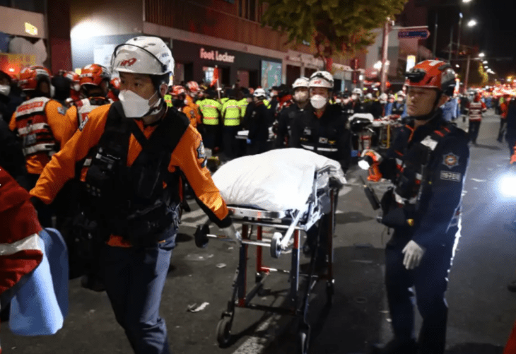 Seoul firefighters moving a body