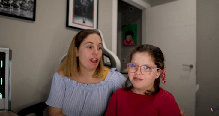 a mother with her daughter analyzing a video on the computer