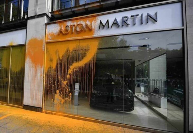 Activists throw paint at Aston Martin exhibit in London