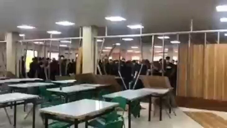 Iranian students tear down cafeteria wall separating men and women in a symbolic act against repression
