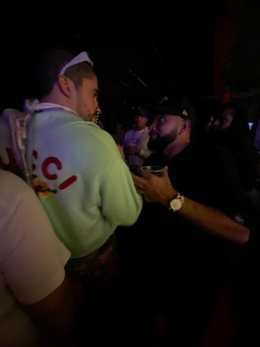 Young Colombian talking to Bad Bunny at an exclusive party that he got into