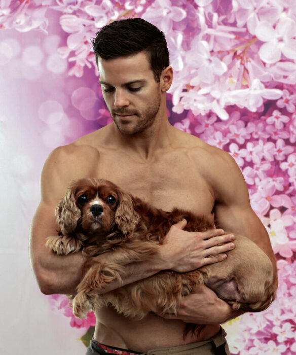 bombero posando para calendario con un perro café