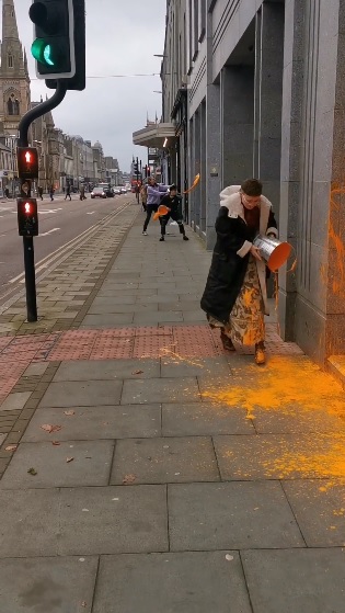 Activists throw paint at Aston Martin exhibit in London