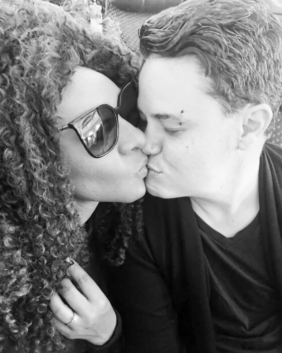 Black and white photograph of M'balia with her husband Alex Tinajero kissing