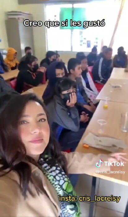 selfie que muestra a una maestra con su alumnos viendo el mundial en la escuela 