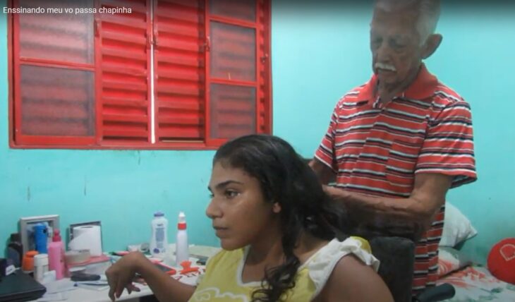 Grandfather combing his 23 year old granddaughter with cerebral palsy