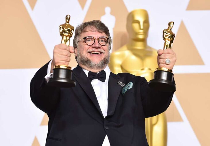 Guillermo del Toro carrying his two Oscar statuettes for the Shape of Water