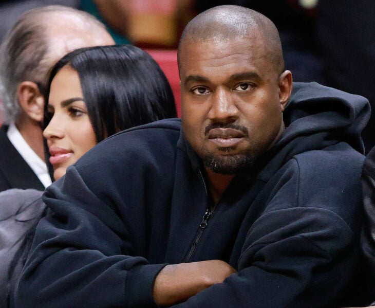 Kim Kardashian and Kanye West "Ye" sitting at a public event 