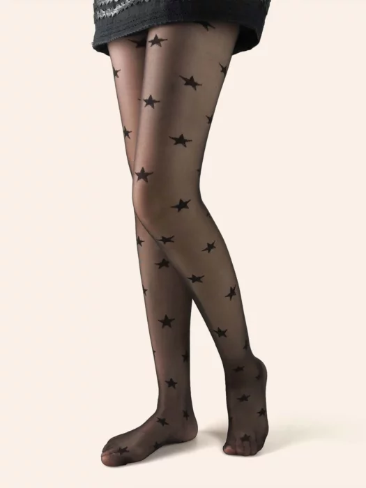 Woman's legs in black skirt and black stockings with star print