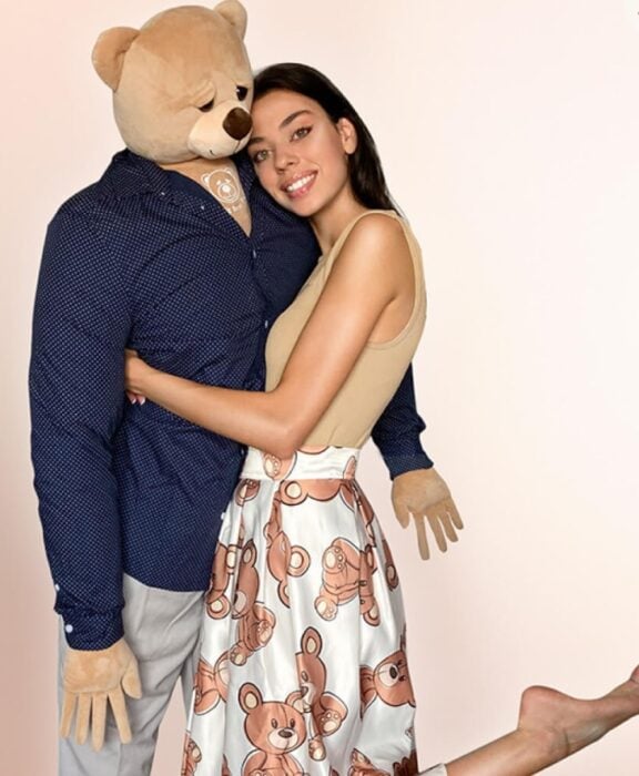 Woman hugging giant teddy bear