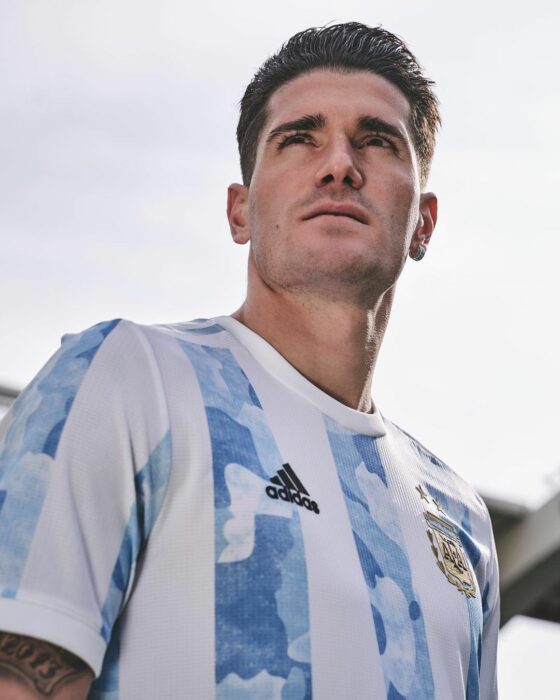 Rodrigo de Paul sin barba con playera azul rayas blancas