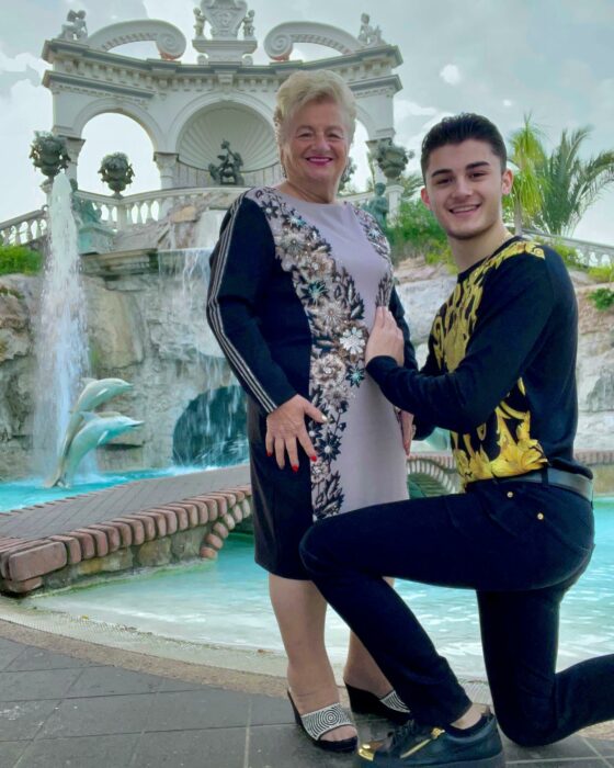 Photograph of a 76-year-old woman with her 19-year-old boyfriend in front of their luxurious mansion in Italy 