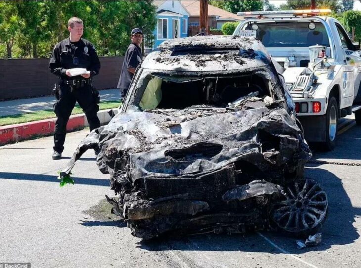 auto destrozado después de un accidente es arrastrado por una grúa un policía estadounidense verifica el momento 