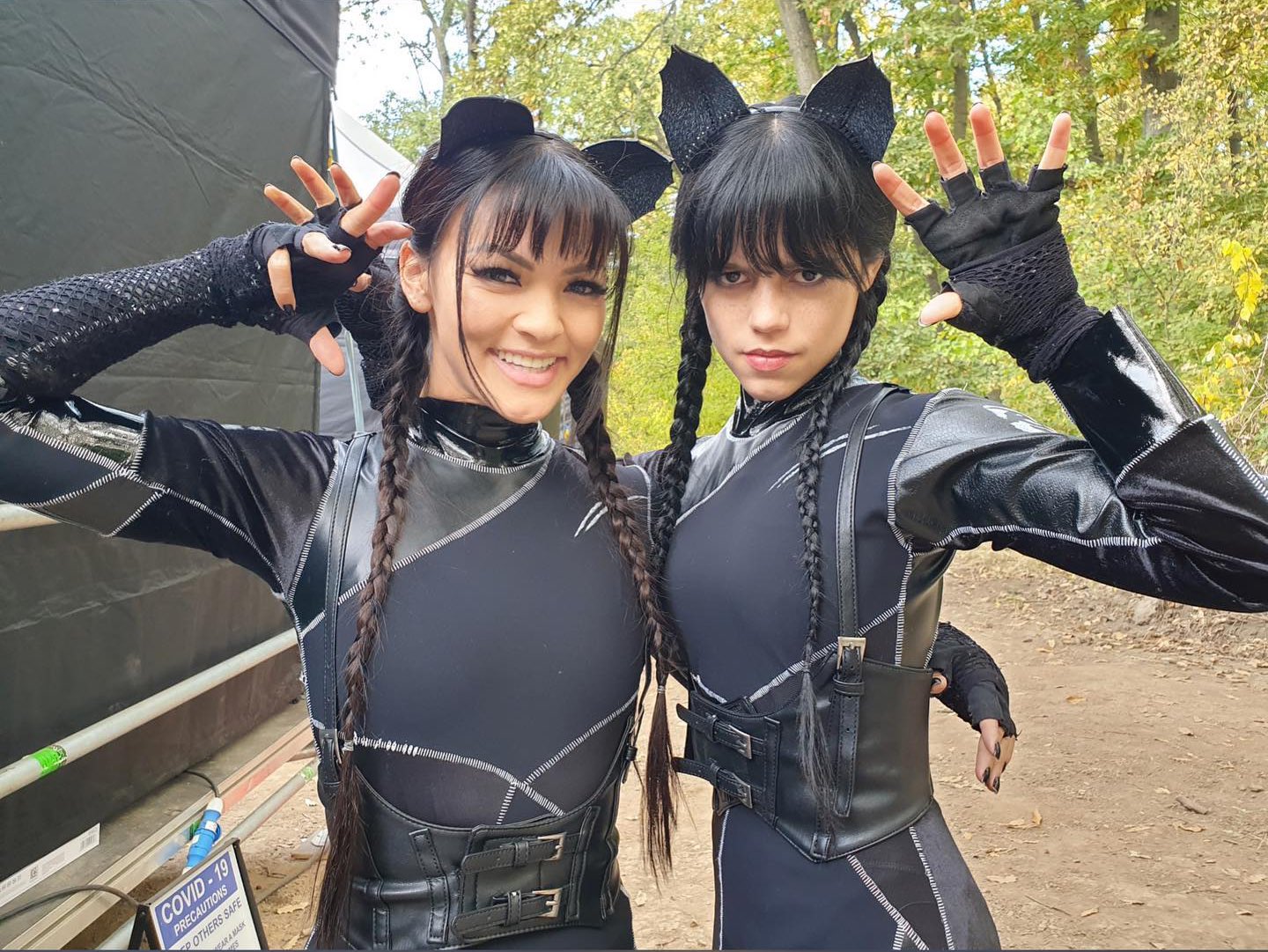 Image showing Jenna Ortega posing with her stunt double dressed as black ki...