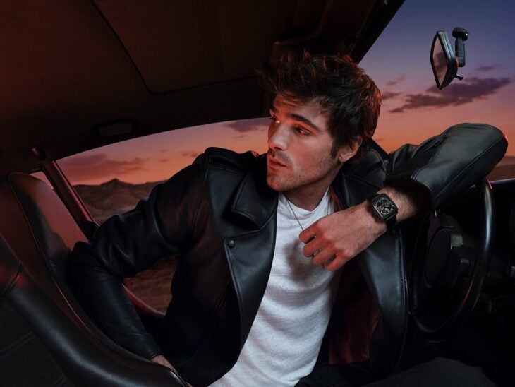 Jacob Elordi posing in car at sunset