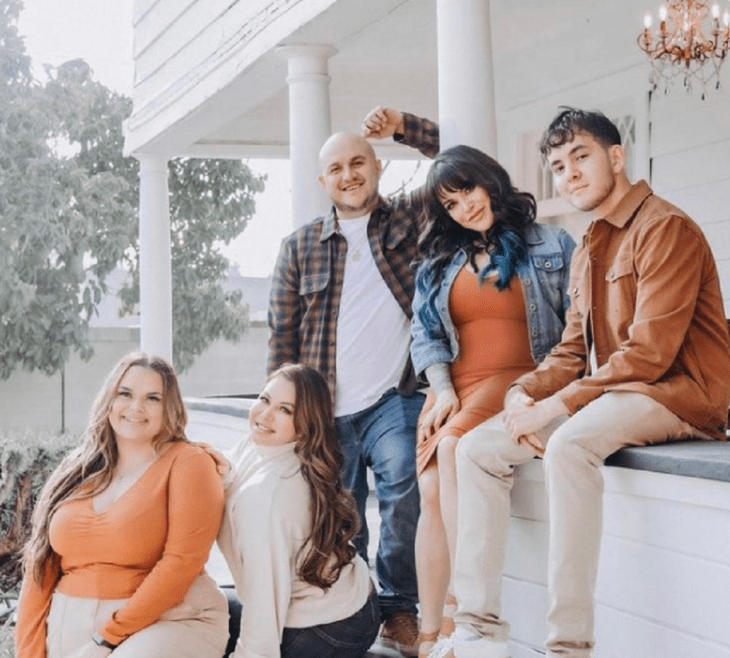 Jenni Rivera's children posing outside her house wear casual clothes 