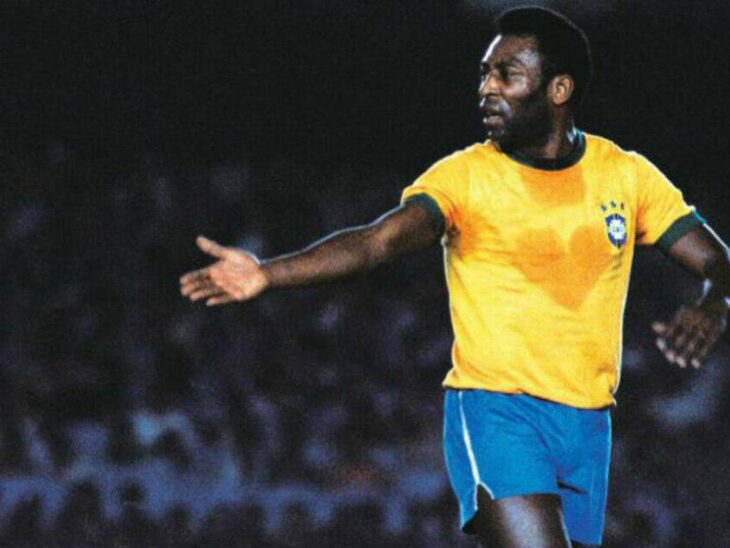 Pelé in the field with his yellow shirt