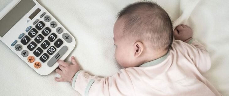 baby lying with a calculator