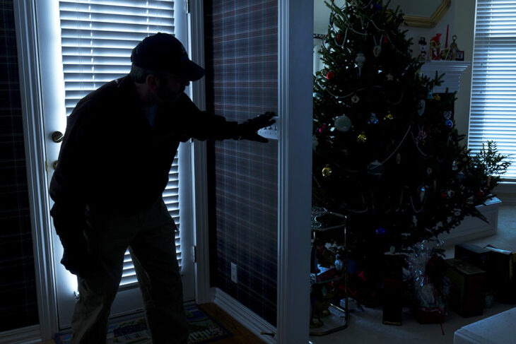 Burglar breaking into house at night