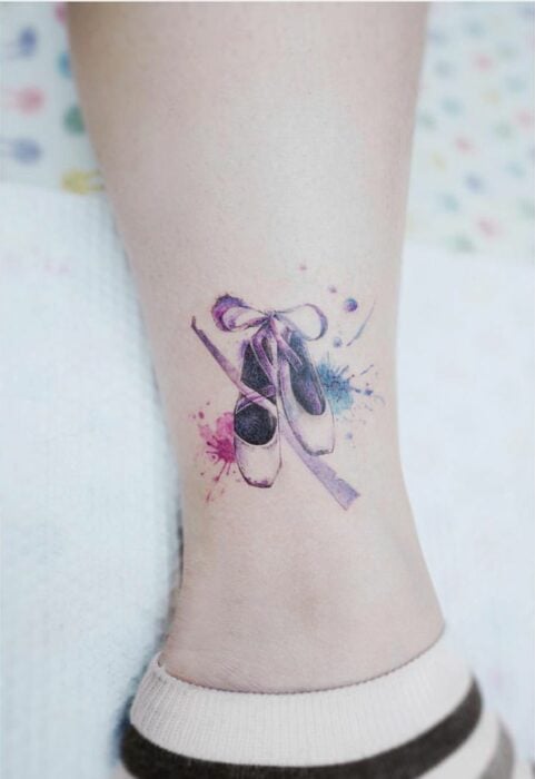 Leg with ballet shoes tattoo