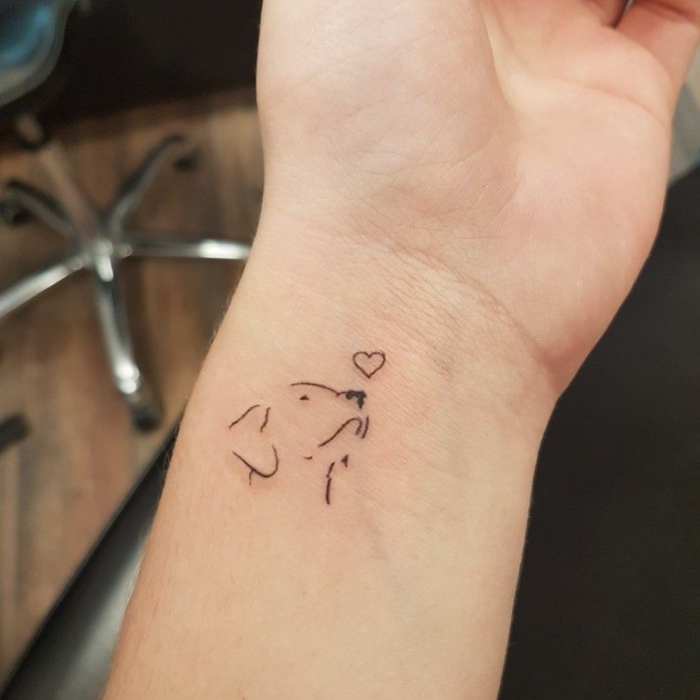 Wrist with Dog and Heart Silhouette Tattoo