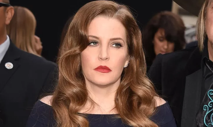 Lisa Marie Presley in an image of an event wears a black dress and loose hair