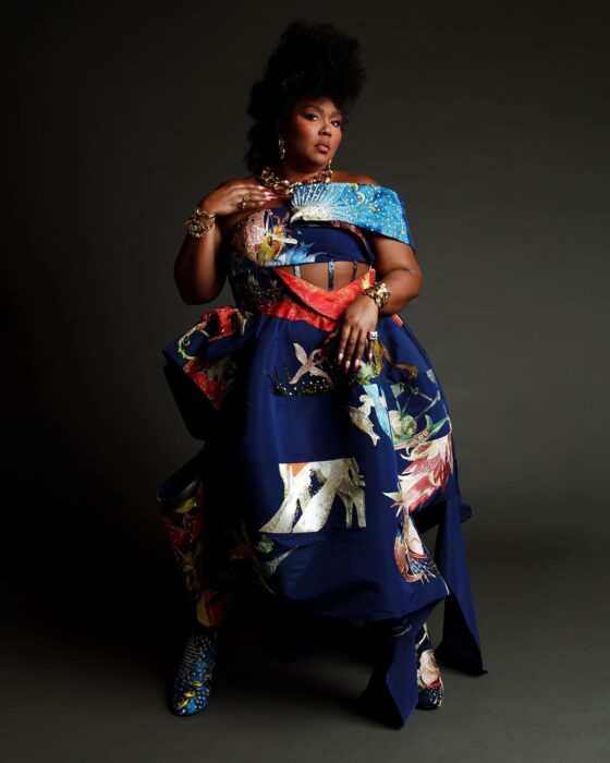 Lizzo posing for a session in a blue suit 